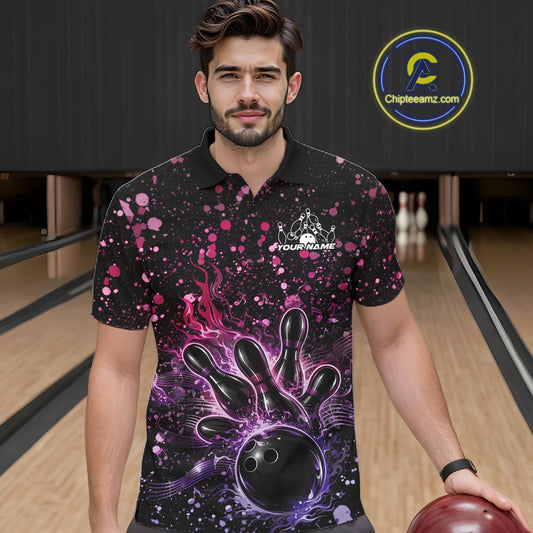 Male model wearing a black bowling polo shirt at the lane with fiery bowling artwork and pink-purple paint splatter details.