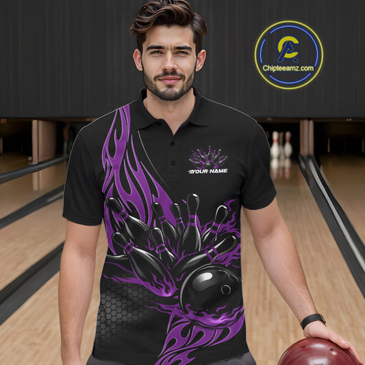 Male model seen from the front in a bowling lane wearing a black polo shirt featuring a purple flaming black bowling ball striking pins in a dynamic sports action design.