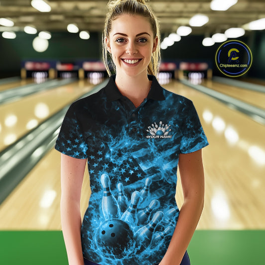 Female model wearing a black and blue bowling polo in a bowling alley with fiery bowling ball and pin graphics.