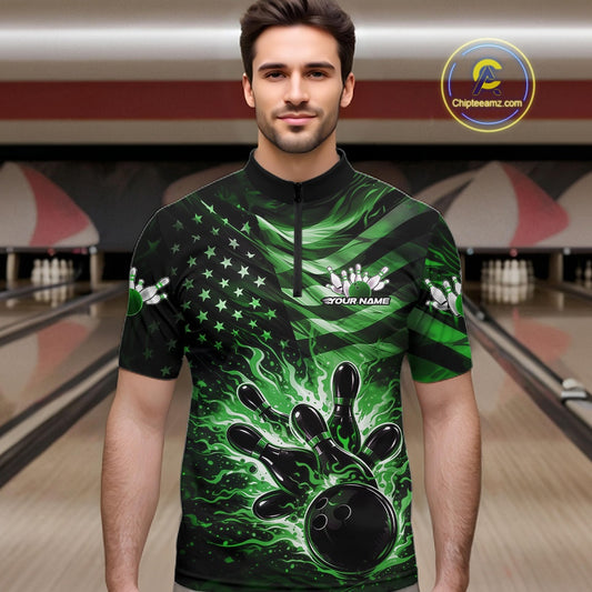 Male model wearing a black bowling quarter-zip shirt at the bowling lane with green flame bowling graphics and patriotic details.