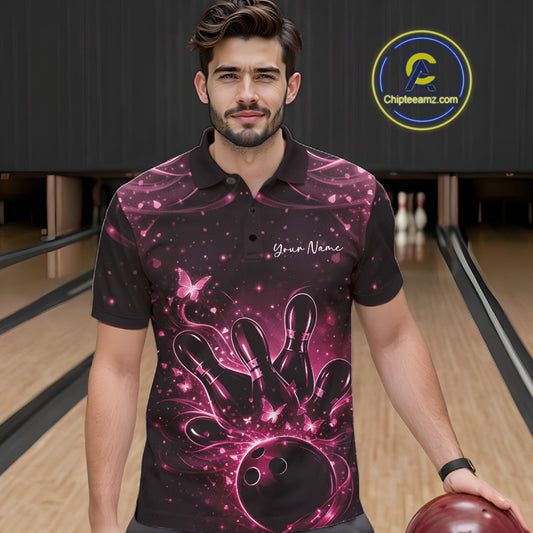 Male model in a black and pink bowling polo shirt at the lane with luminous butterfly bowling graphics.