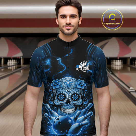 Male model at a bowling lane wearing a black and blue quarter-zip bowling shirt with colorful sugar skull artwork and bowling accents.