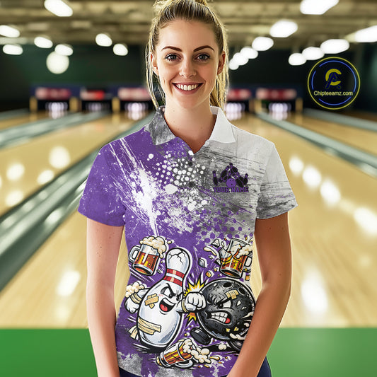 Front view of a female model in a bowling lane wearing a purple and white grunge splatter polo shirt with humorous bowling ball and pin fighting artwork.