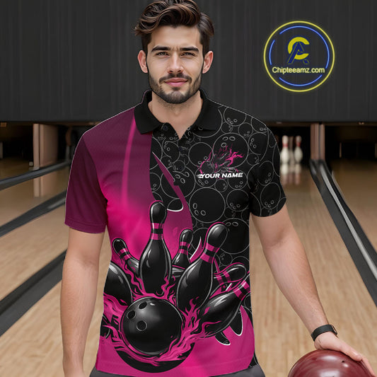 Front view of a male model in a bowling lane wearing a black and pink polo shirt with flaming black bowling ball striking pins and dynamic bowling graphics.