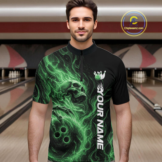 Male model wearing a black bowling quarter-zip shirt in a bowling alley featuring a skull clutching a bowling ball with swirling green energy flames