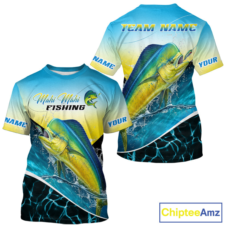 Front and back views of a customizable short-sleeve t-shirt with a vibrant all-over print featuring a yellow and blue mahi-mahi fish, water splashes, and customizable text placeholders like 'TEAM NAME' and 'NAME'.