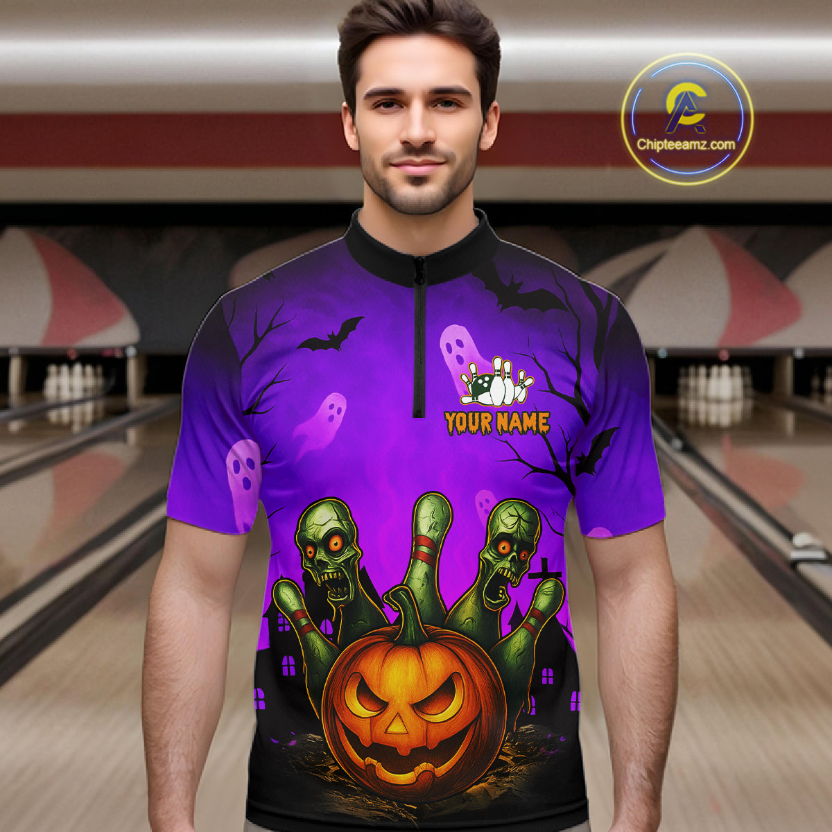 A man wearing a purple Halloween-themed short-sleeve quarter-zip shirt with a graphic print of a jack-o'-lantern, green zombies, ghosts, bats, and bowling pins, set against a blurred bowling alley background. 