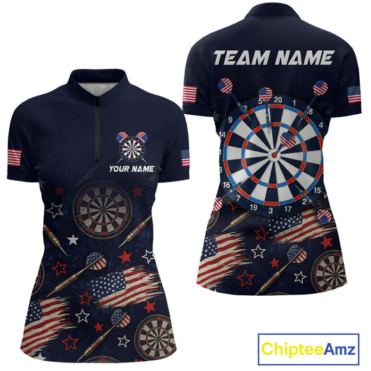 Front and back views of a women's short-sleeve quarter-zip polo shirt in navy blue, featuring a patriotic American flag and dartboard theme with stars, stripes, darts, and a large dartboard graphic on the back. The back also has 'TEAM NAME' printed across the shoulders.