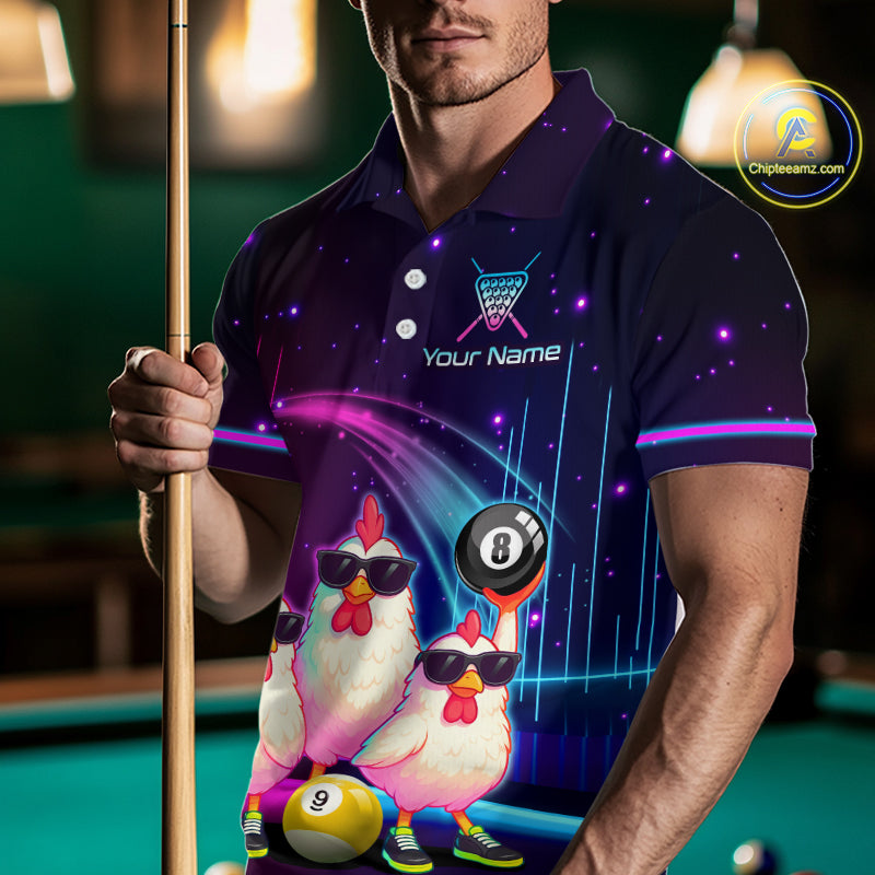 A man wearing a custom-printed polo shirt in a pool hall setting, holding a pool cue. The shirt features a dark purple and black starry space pattern with two cartoon chickens wearing sunglasses, a 9-ball, and a 8-ball, along with the text 'Your Name'.