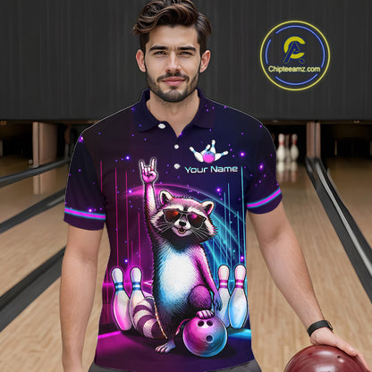 A man in a bowling alley wearing a custom short-sleeve polo shirt with a colorful raccoon graphic, bowling pins, and neon purple and blue starry patterns. 