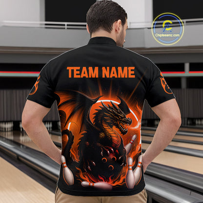A man viewed from behind wearing a black bowling shirt with a large orange and black dragon graphic and the text 'TEAM NAME' across the upper back. Bowling lanes are visible in the background