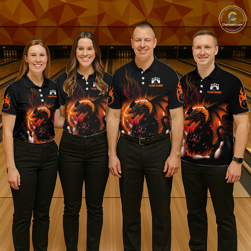 Four people standing in a bowling alley wearing matching black short-sleeve polo shirts with a large fiery dragon graphic on the front and black pants.