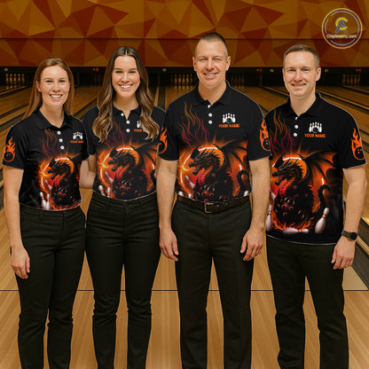 Four people standing in a bowling alley wearing matching black short-sleeve polo shirts with a large fiery dragon graphic on the front and black pants.