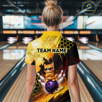 Person wearing a bowling-themed shirt with a cat design in a bowling alley.