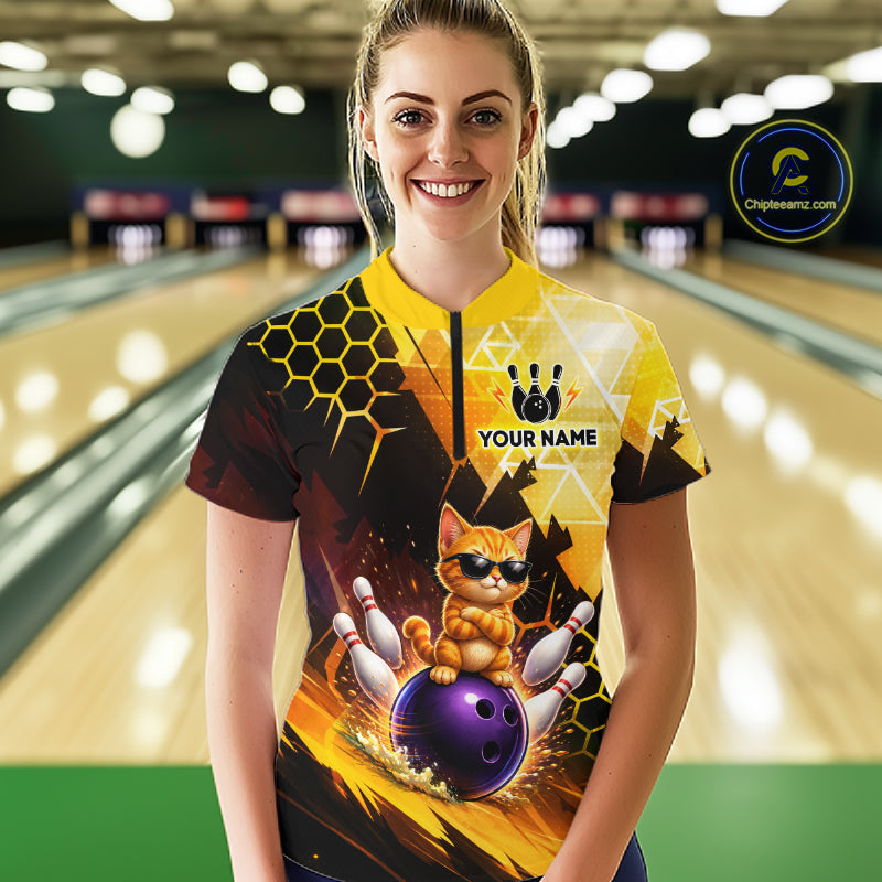 Woman wearing a custom bowling shirt with a cat design in a bowling alley.