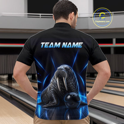 Person wearing a black bowling shirt with a walrus design and 'TEAM NAME' text on the back, standing in a bowling alley.