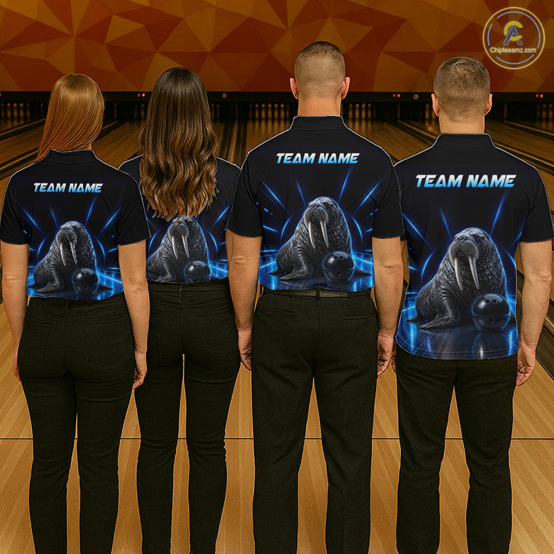 Four people wearing black shirts with a team name and graphic of a walrus on a bowling alley.