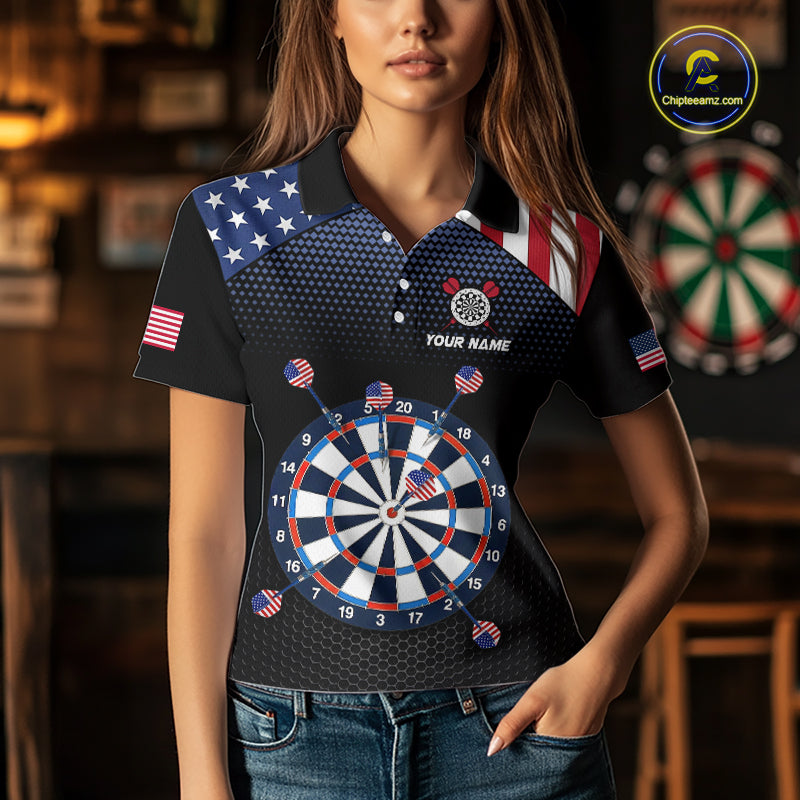A woman wearing a custom patriotic dart polo shirt featuring an American flag dartboard graphic in a professional dart room.