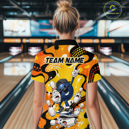Person wearing a colorful bowling shirt with cartoon characters in a bowling alley.