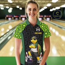 Load image into Gallery viewer, A woman stands in a bowling alley wearing a custom short-sleeve bowling shirt with a turtle graphic and 'YOUR NAME' printed on the front. The shirt features green and black turtle-scale patterns on the sleeves and shoulders, with a black center panel showing a cartoon turtle wearing sunglasses and bowling accessories.