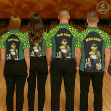 Load image into Gallery viewer, Four people standing with their backs to the camera in a bowling alley, wearing matching green and black bowling shirts with a cartoon turtle graphic and 'TEAM NAME' printed on the back.
