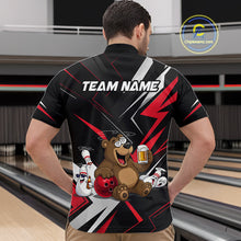 Load image into Gallery viewer, Person wearing a black bowling shirt with a bear graphic and 'TEAM NAME' text in a bowling alley.