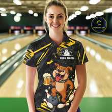 Load image into Gallery viewer, A woman wearing custom black yellow bulldog bowling polo shirt front view featuring a playful cartoon mascot, bowling ball and beer mug, displaying Your Name, at the bowling alley