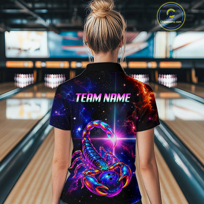 A woman viewed from behind wearing a short-sleeve collared bowling shirt with a vivid cosmic scorpion graphic and the text 'TEAM NAME' on the back. The shirt has a black base with bright purple, blue, pink, and orange nebula-style artwork.