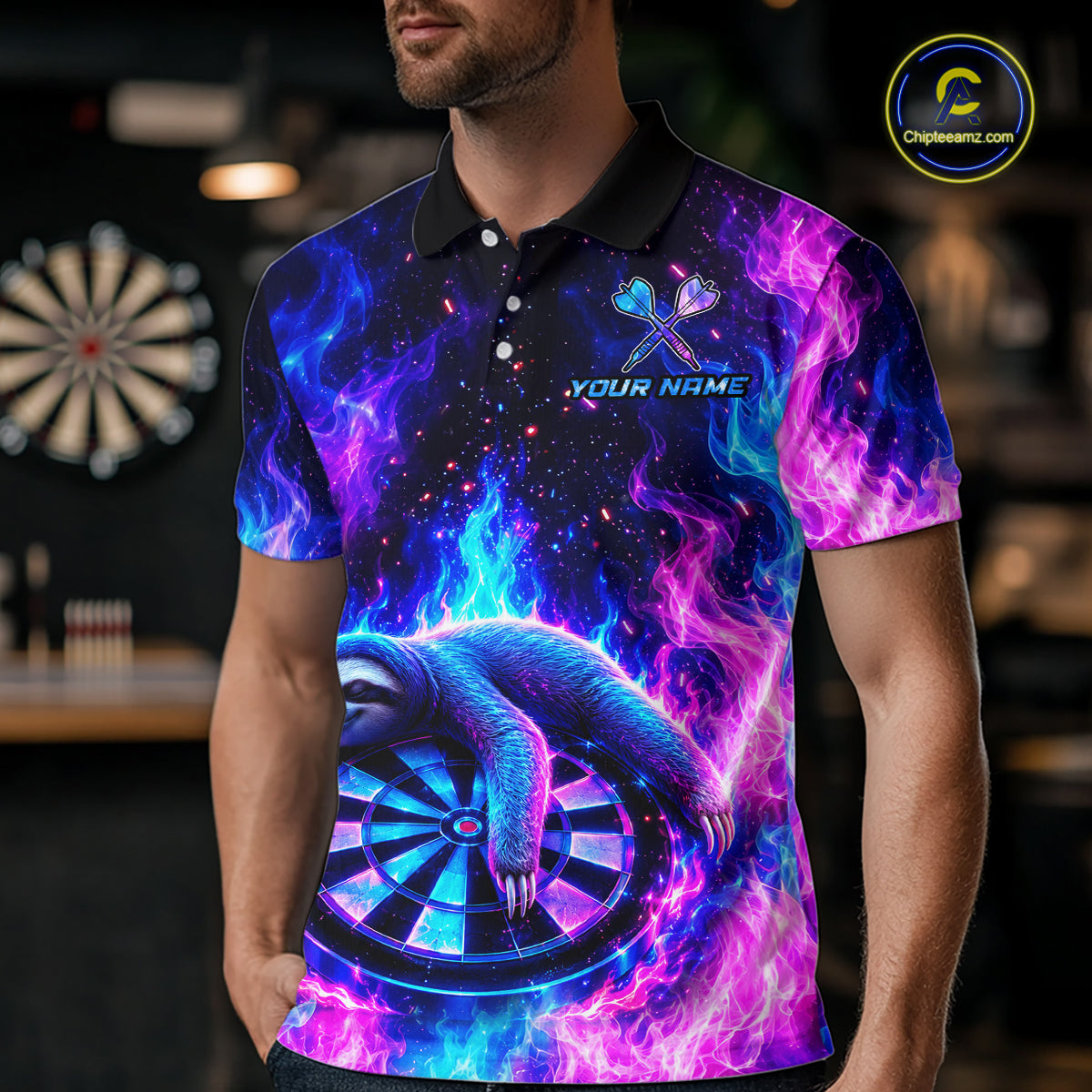 A man wearing a custom galaxy dart polo shirt featuring a neon sloth holding a dartboard with glowing blue and purple cosmic artwork in a professional dart room.