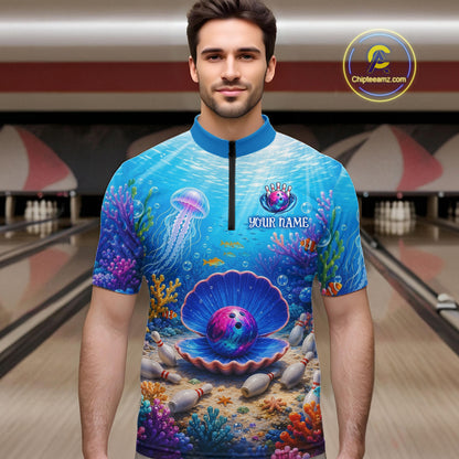 Man wearing a colorful bowling shirt with an underwater design in a bowling alley.