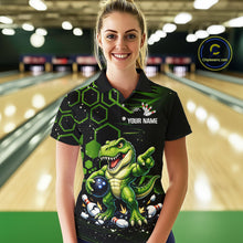 Load image into Gallery viewer, A woman wearing a black and green bowling-themed polo shirt with a dinosaur graphic, standing in a bowling alley. The shirt features a green T-Rex holding bowling balls, green hexagonal patterns, and a customizable name print area.