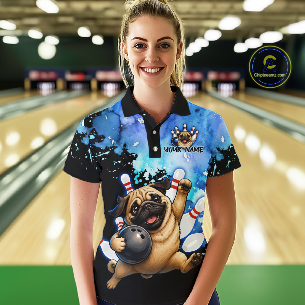 A woman stands in a bowling alley wearing a custom short-sleeve polo shirt with a cartoon pug bowling graphic and the text 'YOUR NAME'. The background shows blurred bowling lanes