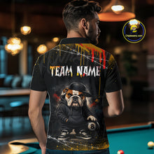 Load image into Gallery viewer, A back view of a custom black billiards polo shirt worn by a male model. The shirt features a funny hip hop bulldog on the back, with a large white 'TEAM NAME' text placeholder. The background is a billiards room with a table and hanging lights.