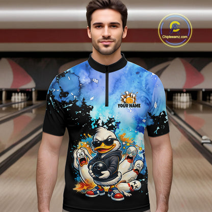 Man wearing a colorful t-shirt with cartoon characters in a bowling alley.