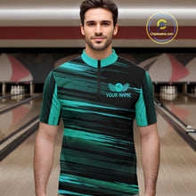 Load image into Gallery viewer, Male model wearing a custom black turquoise bowling quarter-zip shirt front view featuring a turquoise bowling ball emblem, dynamic turquoise brush stroke pattern and striped design at the bowling alley