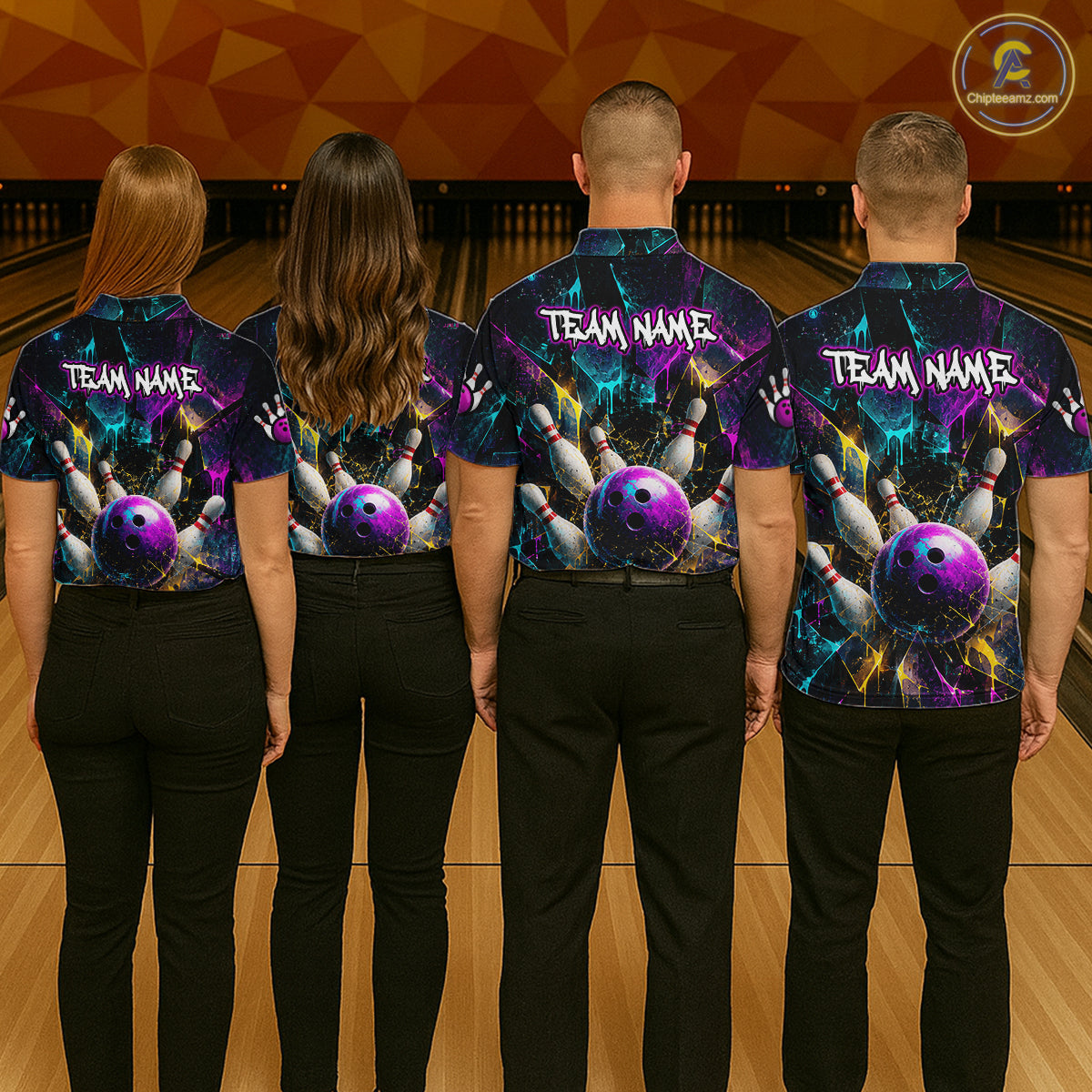 Four people standing in a bowling alley, viewed from behind, wearing matching custom bowling shirts with a vibrant purple, blue, and black cosmic design featuring bowling balls and pins, with 'TEAM NAME' printed on the back.