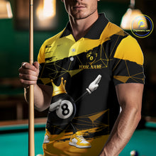 Load image into Gallery viewer, Man wearing custom black and gold geometric crown 8 ball billiard polo shirt standing at a pool table holding a cue stick in a billiard room