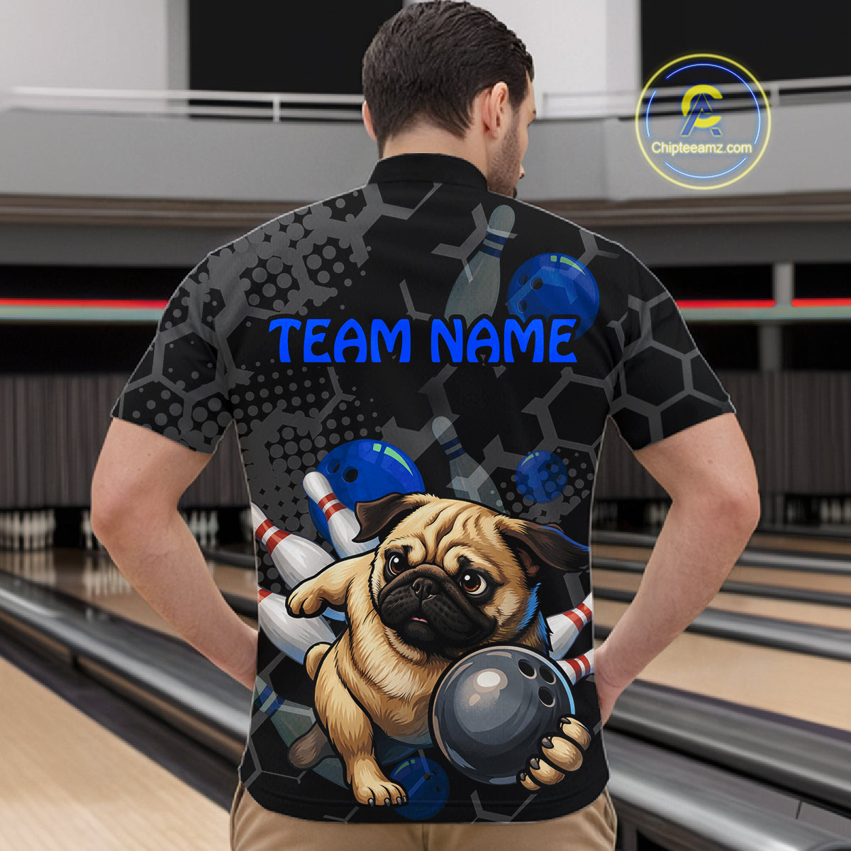 Person wearing a bowling-themed shirt with a pug graphic in a bowling alley.