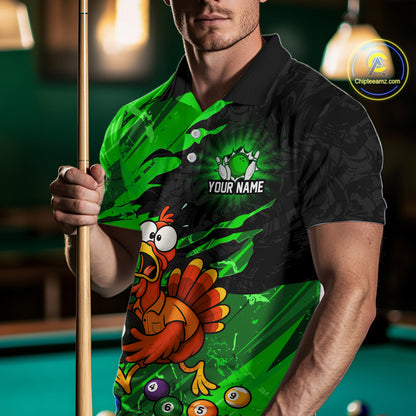 A man wearing a custom green and black polo shirt with a cartoon turkey graphic and pool balls, holding a pool cue in a dimly lit pool hall. 
