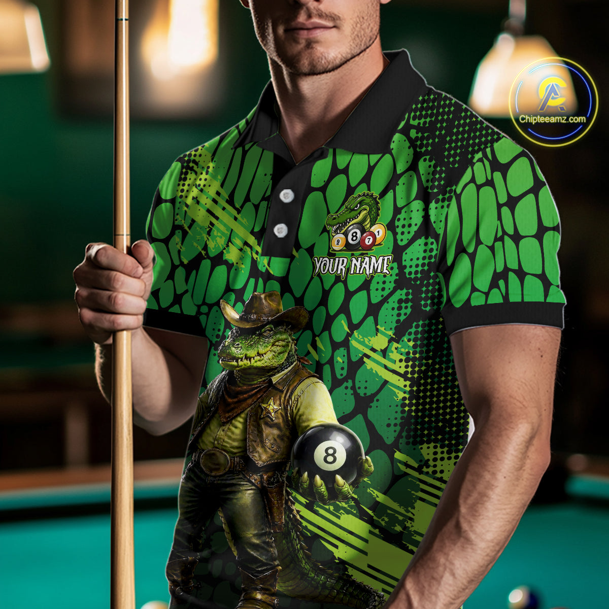 Person wearing a green and black patterned shirt with a crocodile graphic, holding a pool cue and 8-ball on a pool table.