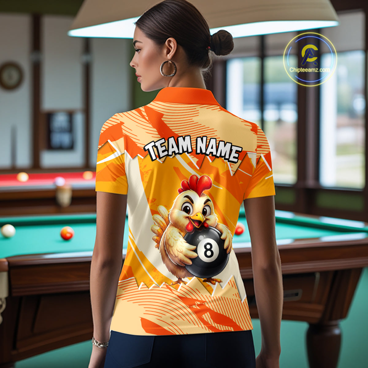 Woman wearing a colorful shirt with a chicken and number 8 design in a pool hall.