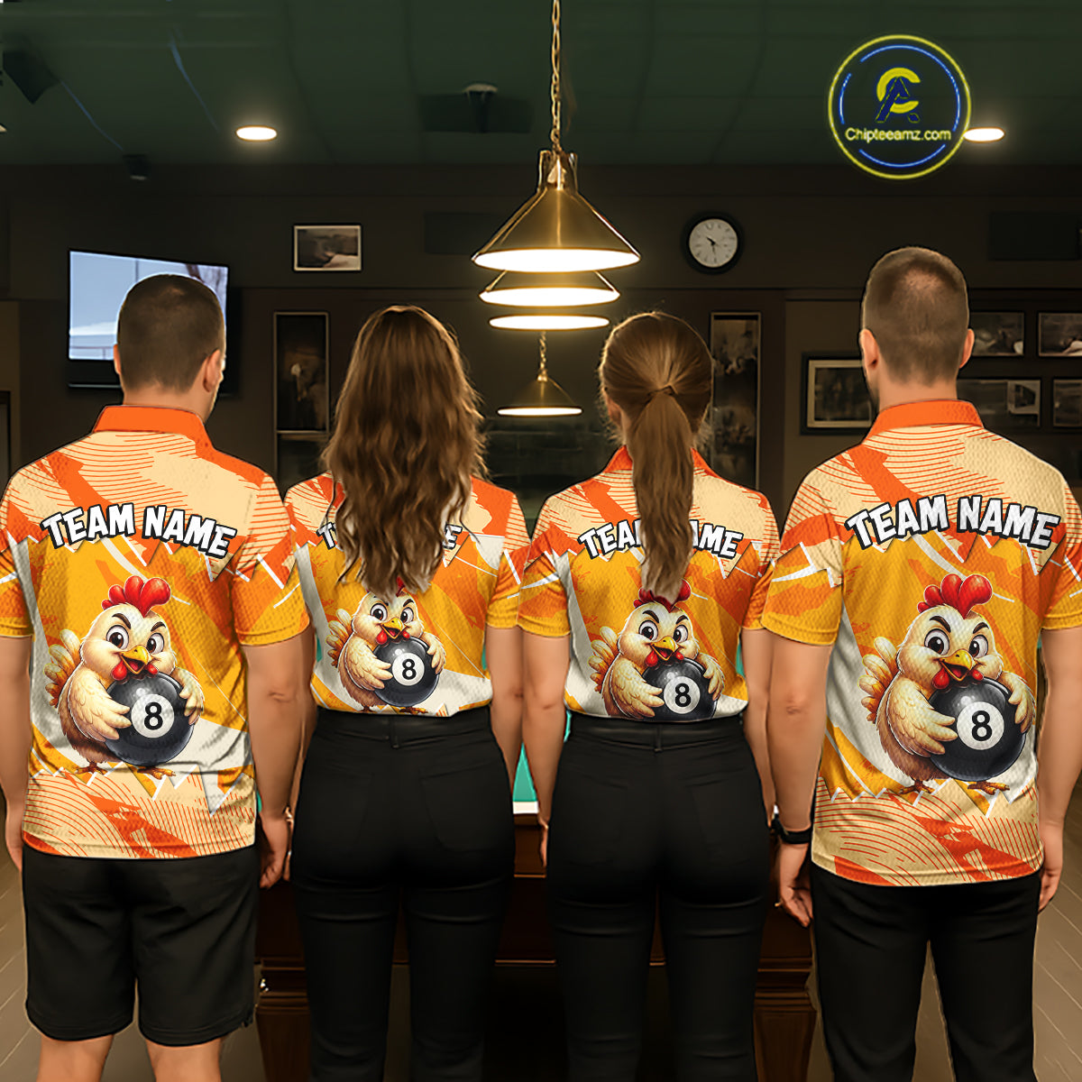 Four people wearing matching bowling team shirts in a bowling alley.