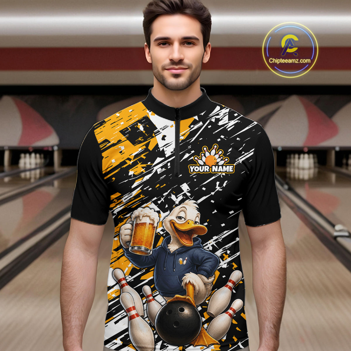 A man wearing a short-sleeve bowling-themed quarter-zip shirt with a black, white, and yellow paint-splatter design and a cartoon duck holding a bowling ball and beer mug. The background shows a blurred bowling alley.