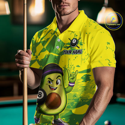 Person wearing a colorful shirt with an avocado character holding a pool cue in front of a pool table.