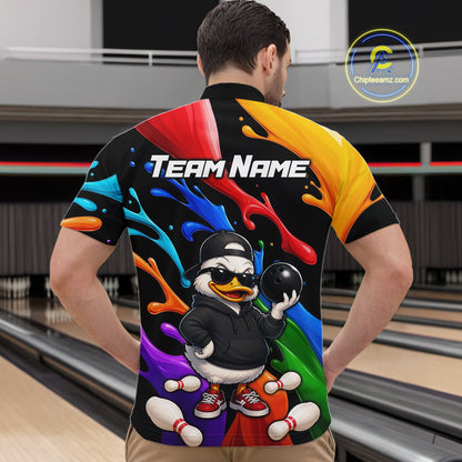 A man viewed from behind wearing a short-sleeve bowling shirt with a colorful graphic print. The shirt features a black base with vibrant paint splashes in red, yellow, blue, orange, green, and purple, a cartoon duck holding a bowling ball, and the text 'Team Name' across the upper back.