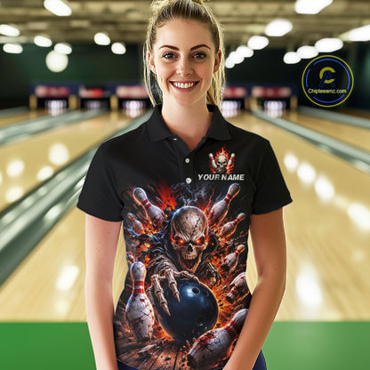 Person wearing a black bowling shirt with a colorful design in a bowling alley.