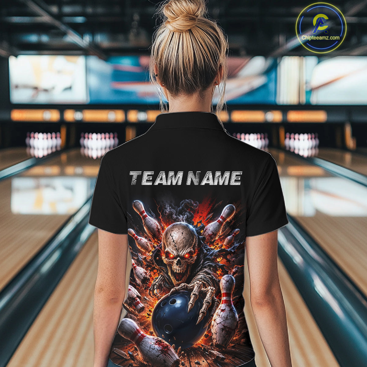 Person wearing a black polo shirt with a graphic design and 'TEAM NAME' text in a bowling alley.