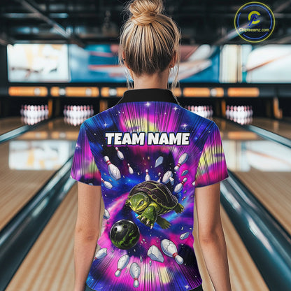 Person wearing a colorful bowling shirt with a turtle design and 'TEAM NAME' text in a bowling alley.