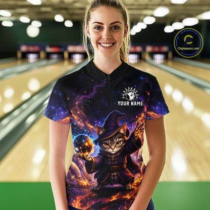 Person wearing a colorful bowling shirt with a cat design in a bowling alley.
