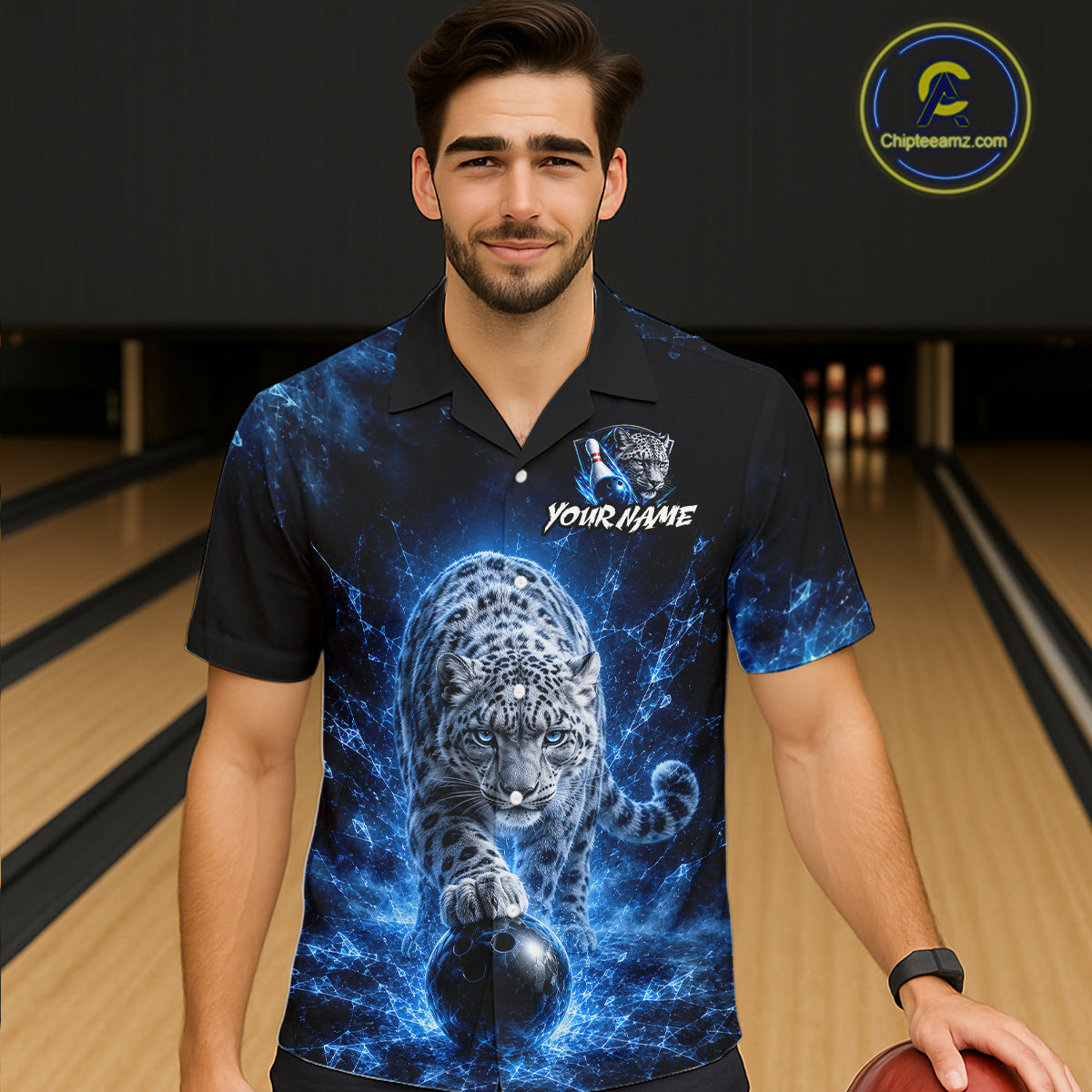 Man wearing a bowling shirt with a blue and black design of a leopard and bowling ball on a bowling alley.